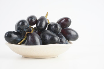 Fresh grape fruits plated over the white background