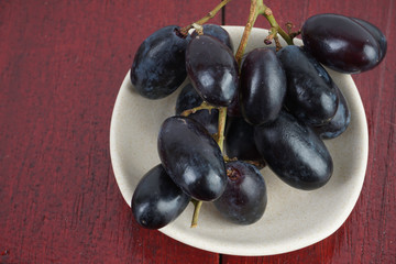 Fresh grape fruits plated over the wooden background
