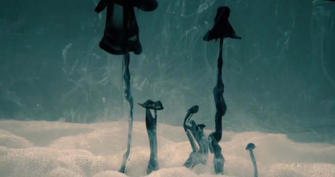 Strange ink clouds appearing from a foam landscape. Underwater alien world theme