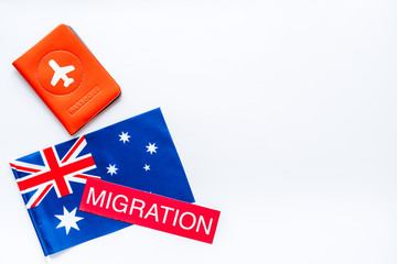 Migration to Australia concept. Australian flag near passport aon white background top-down copy space