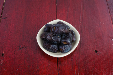 Dates fruit over an old brown table. Selective focus