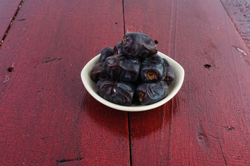 Dates fruit over an old brown table. Selective focus