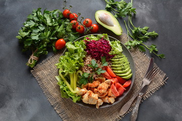 Buddha bowl or salad with red cabbage, cherry tomatoes, grilled chicken, avocado, lettuce,green pepper, parsley and buckwheat. Healthy food concept