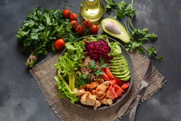 Buddha bowl or salad with red cabbage, cherry tomatoes, grilled chicken, avocado, lettuce,green pepper, parsley and buckwheat. Healthy food concept