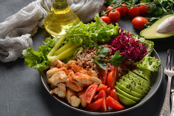 Buddha bowl or salad with red cabbage, cherry tomatoes, grilled chicken, avocado, lettuce,green pepper, parsley and buckwheat. Healthy food concept