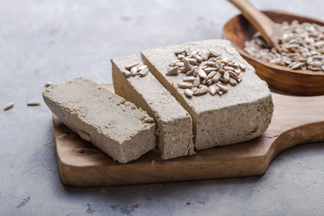 Sunflower halva with seeds  on wooden background. Festive Oriental delicacy