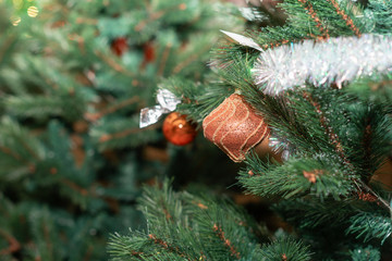 Close-up Christmas orange decoration on the Xmas tree on blurred Christmas background. Happy New Year concept.