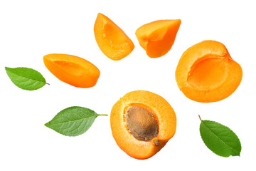 apricot fruits with slices and green leaf isolated on white background. top view