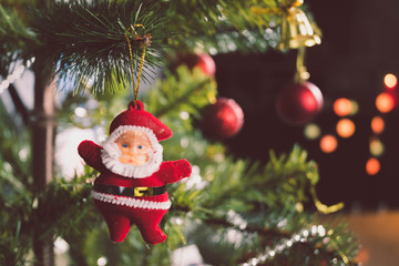 Obraz premium Santa Claus doll Hanging on the Christmas tree to decorate the Christmas or New Year's Eve. There is space for the copy space.