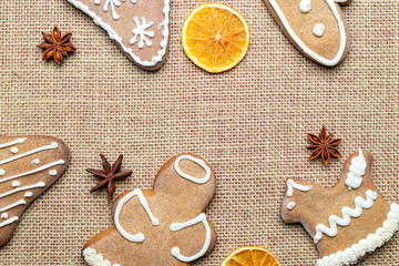 Naklejka na ściany i meble Christmas background. Handmade festive gingerbread cookies. Copy space for text. Winter holidays background mock up