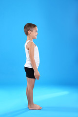 Cute little boy in underwear on light blue background