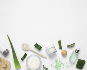 Obraz na płótnie Canvas Flat lay composition with aloe vera and cosmetic products on white background