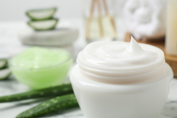 Fototapeta na wymiar Open jar of aloe cream on table, closeup. Organic cosmetics