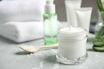 Fototapeta na wymiar Open jar of aloe cream on grey marble table. Organic cosmetics