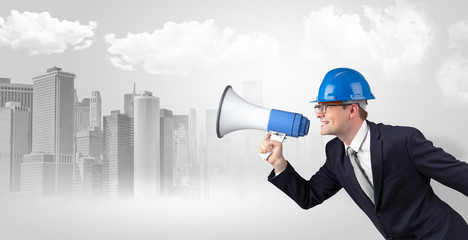Fototapeta premium Young supervisor architect yelling to far big city panorama