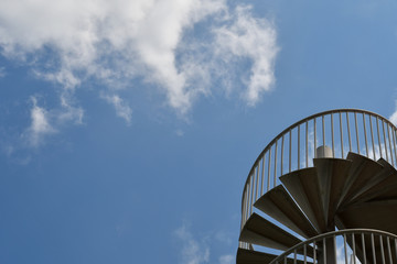 Blue sky and metal spiral staircase
