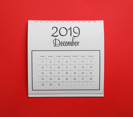 Fototapeta na wymiar December 2019 calendar on red background, top view