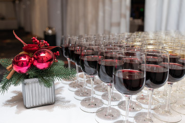 red wine in raw of crystal glasses on the Christmas buffet table