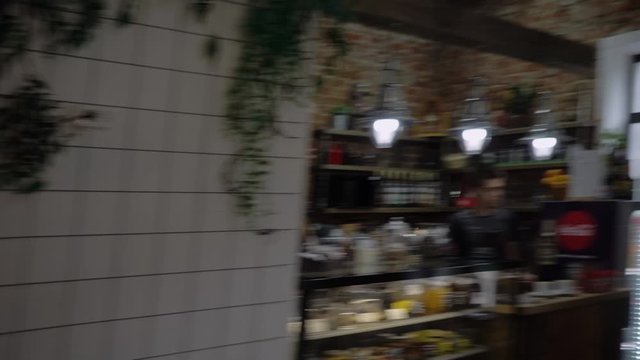 A neon sign that says cafe hanging on the wall in the coffee shop