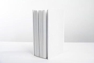 Book with blank cover on white background