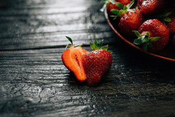 a new crop of juicy and ripe strawberries lies on the table