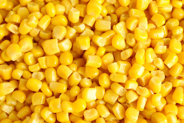 Delicious canned corn kernels as background, top view
