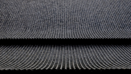 old asian roof clay tiles in dark tone background. 