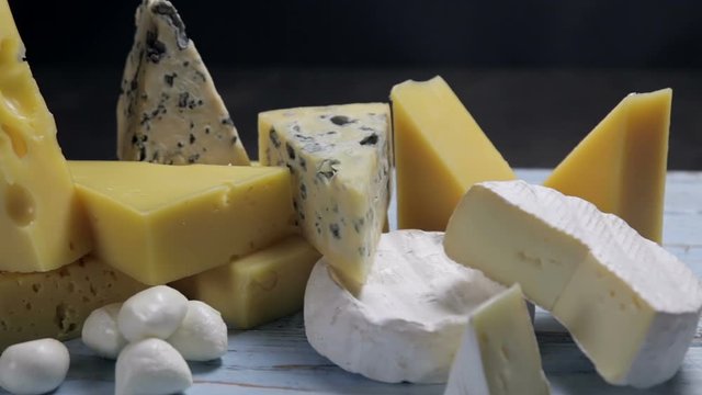 different varieties and types of cheese are on the table