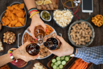 Celebration toast for Christmas with beer at the bar after work, Cheers