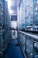 Modern pharmacy storage room, robot hand s are arranging and storing out drugs in a pharmacy