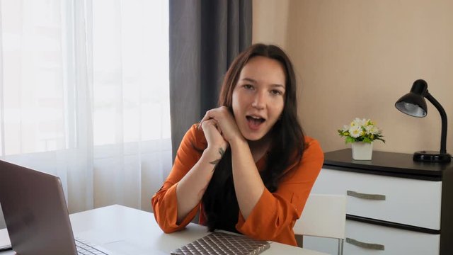 Young beautiful girl blogger actively tells her thoughts to the camera. 
