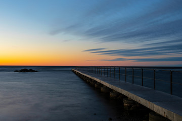 Fototapeta na wymiar Vibrant orange colored sky during summer sunset over the Baltic Sea, Sweden