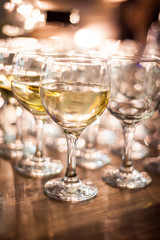 rows of wine glasses on corporate party celebration