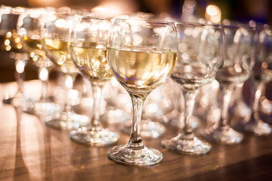 rows of wine glasses on corporate party celebration