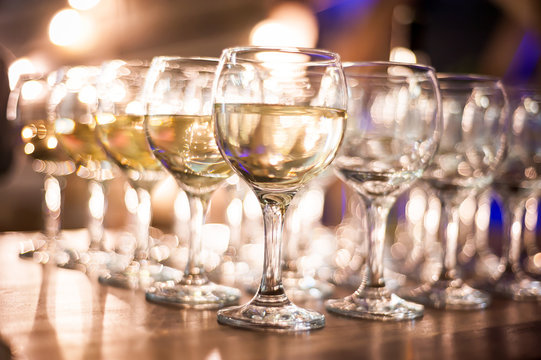 rows of wine glasses on corporate party celebration