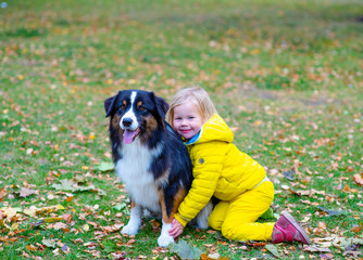 girl walks in autumn Park with a dog