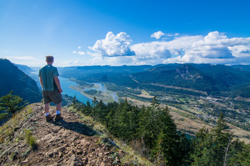 Fototapeta premium Adventurous man standing on top of Munra Point.