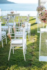 Chair decorated with flowers in Wedding ceremony.