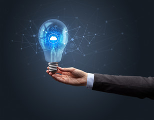 Hand holding light bulb on dark background. Networking idea concept