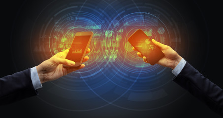 Close up of two smartphones syncing business data