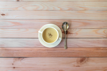 A bowl of mushroom soup, isolated and spoon on table