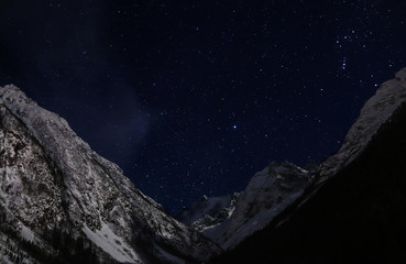 starry sky at night in the snowy mountains