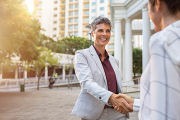 Business woman shaking hands outdoor