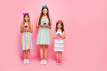 Full length photo of interested ladies with blonde brunette haircut having headbands use gadget wear skirt dress isolated over pink background