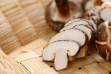 Fototapeta na wymiar Shiitake mushrooms on the wooden background.