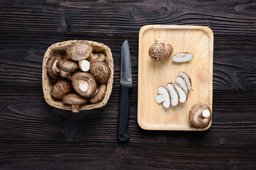 Shiitake mushrooms on the wooden background.