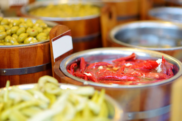 Assorted organic pickled olives, garlic, hot peppers, capers and sundried tomatos sold on a marketplace in Vilnius, Lithuania.
