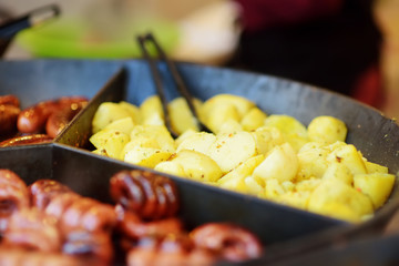 Traditional fried potatos being cooked at the spring market in Vilnius, Lithuania. Variety street food on Easter fair.
