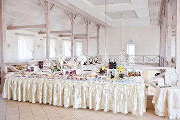 Beautiful wedding set decoration in the restaurant. Candy bar.