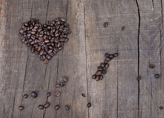 heart shaped in coffee  beans  on a rustic plank background